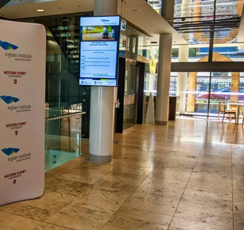 Digital welcome board in the reception foyer of the Ingham Institute